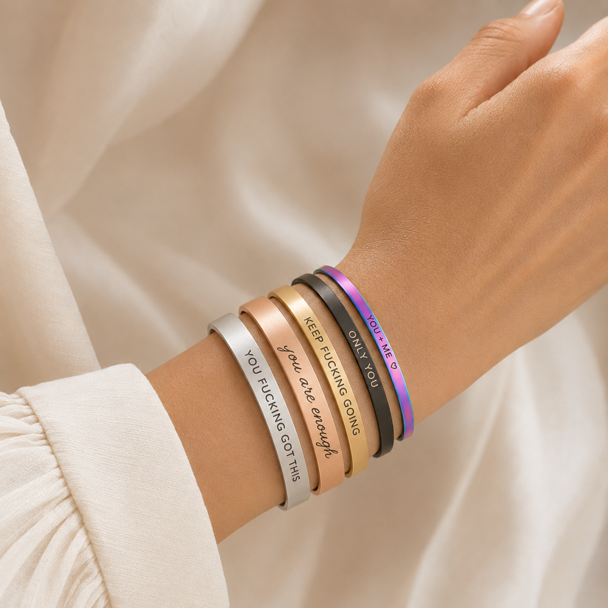 Affirmation bangles in all colours worn together on the wrist
