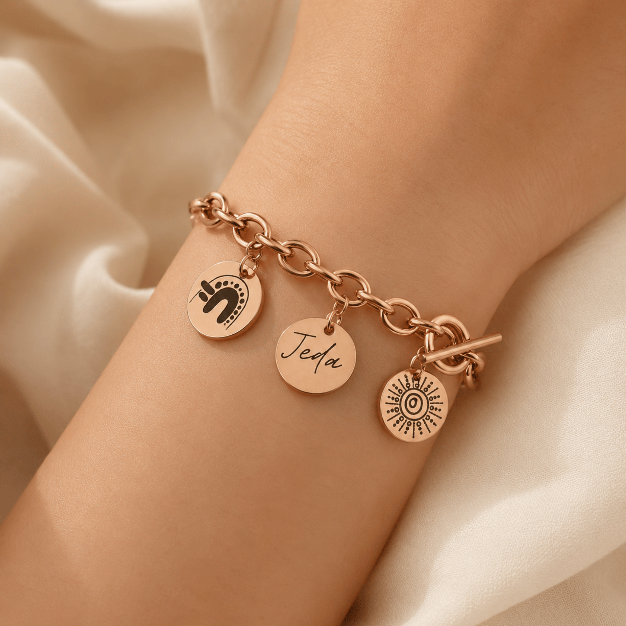Rose gold-plated custom charm bracelet worn on the wrist